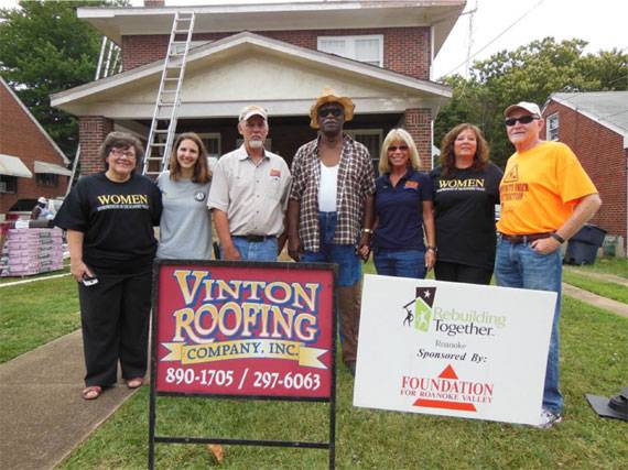 Vinton Roofing Company Inc. staff in front of house
